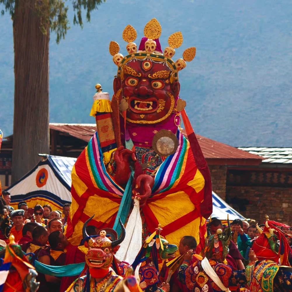 Sacred Cham mask dancers performing at Paro Tshechu 2026 inside Paro Rinpung Dzong Bhutan